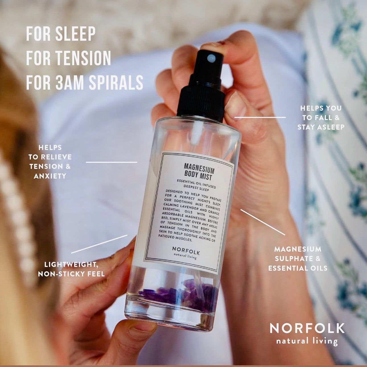 Hand holding Norfolk Natural Living Magnesium Body Mist spray bottle
